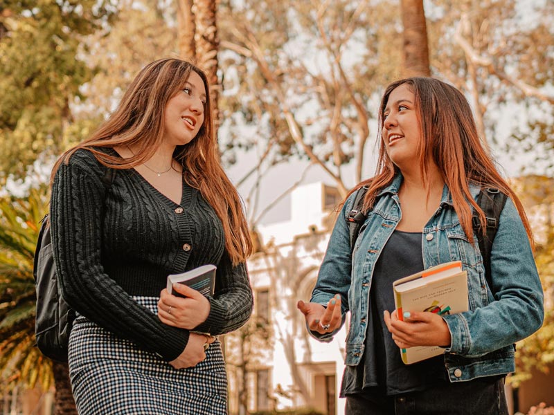 Two female students talking outdoors